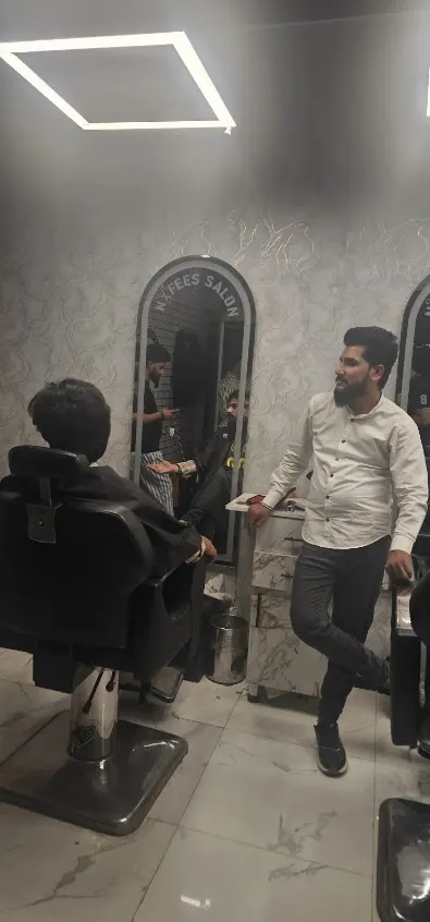 Golden winged shears crest on the Nafees salon wall
